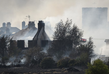 Wildfires rage across Britain amid record temperature