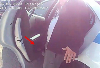 Водитель без прав закинул взятку в салон полицейской машины в Алматы